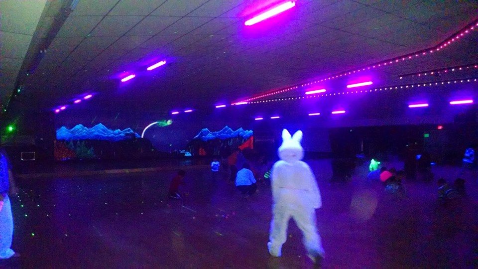 Skaters under the rink lights at AJ Skateworld